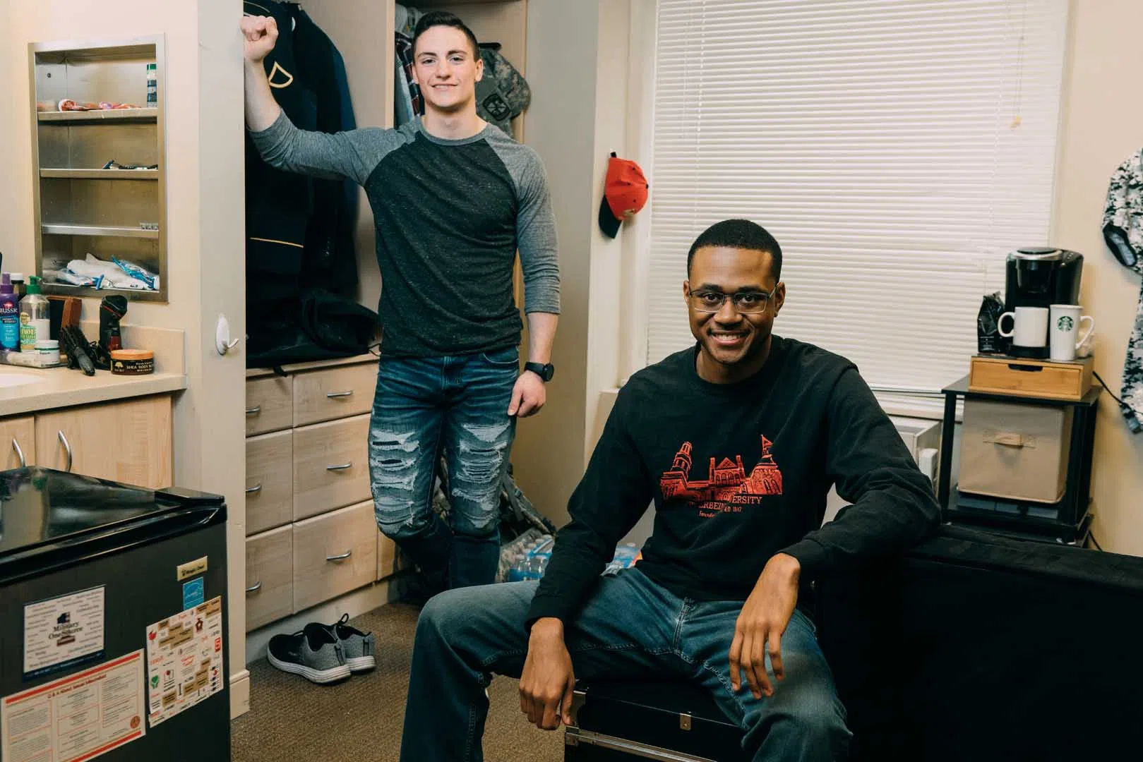 Two upper-level students in their dorm room.