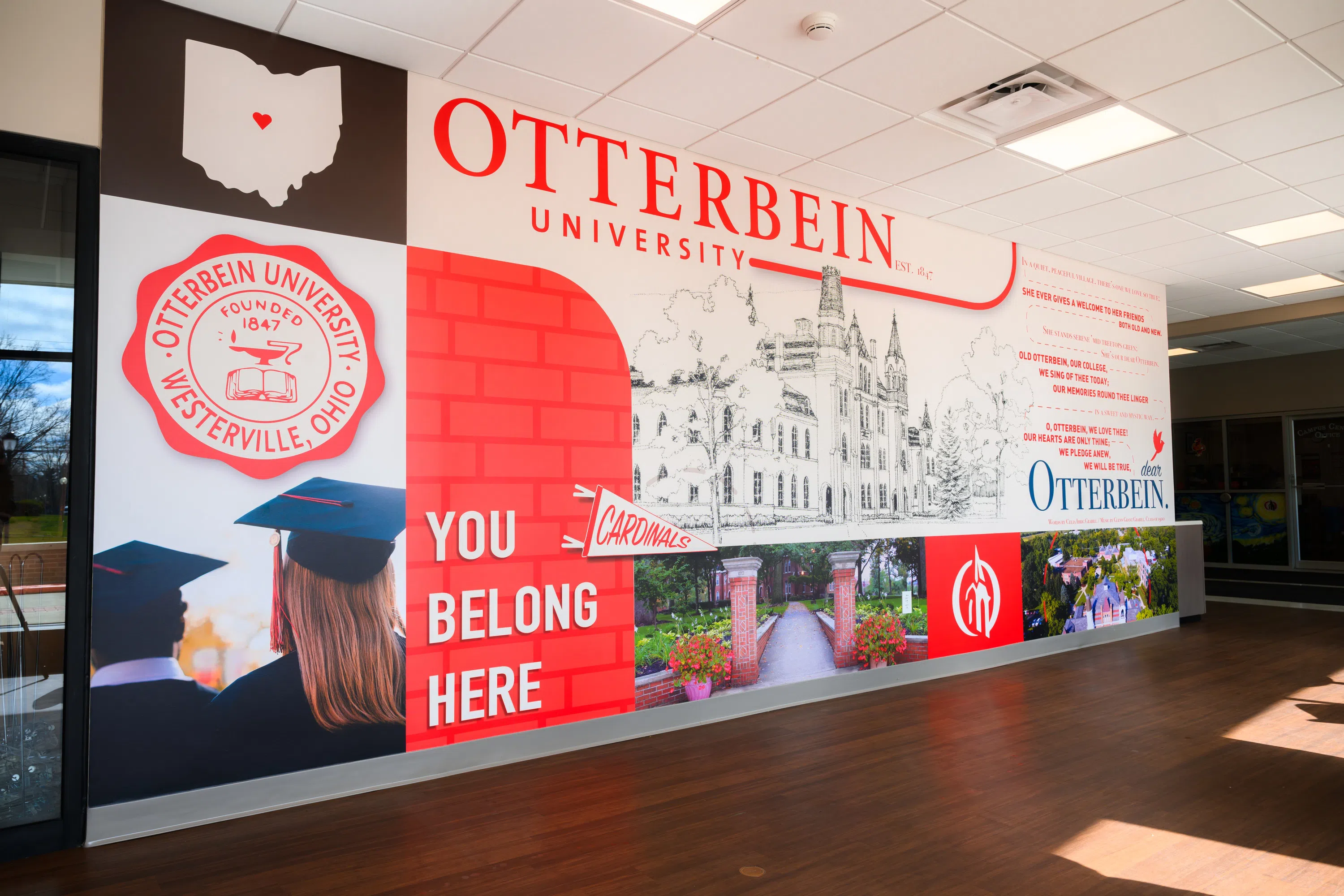 An Otterbein themed wall mural with the Love Song displayed on the right.