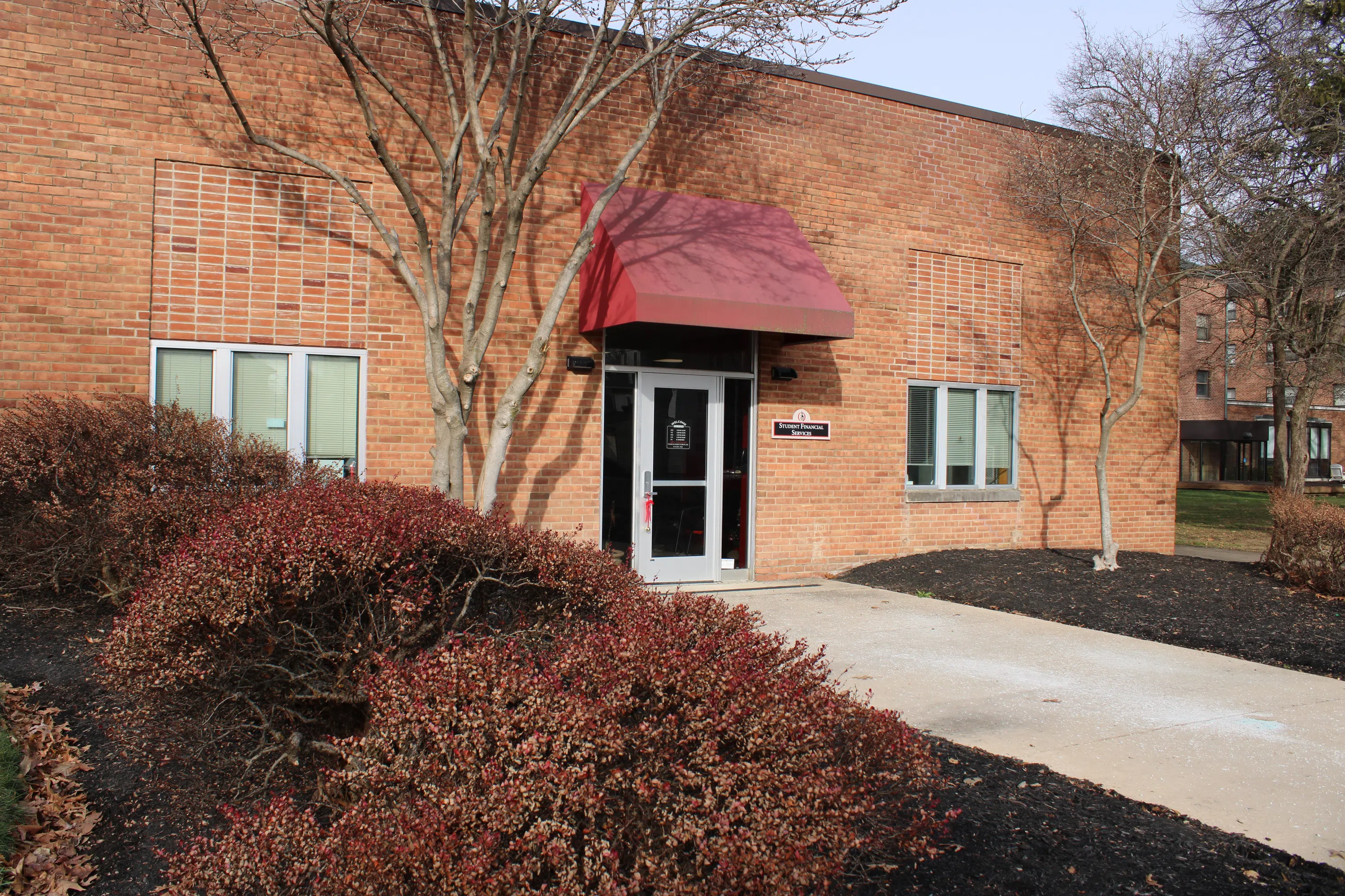 Brick building with a red awning over the door