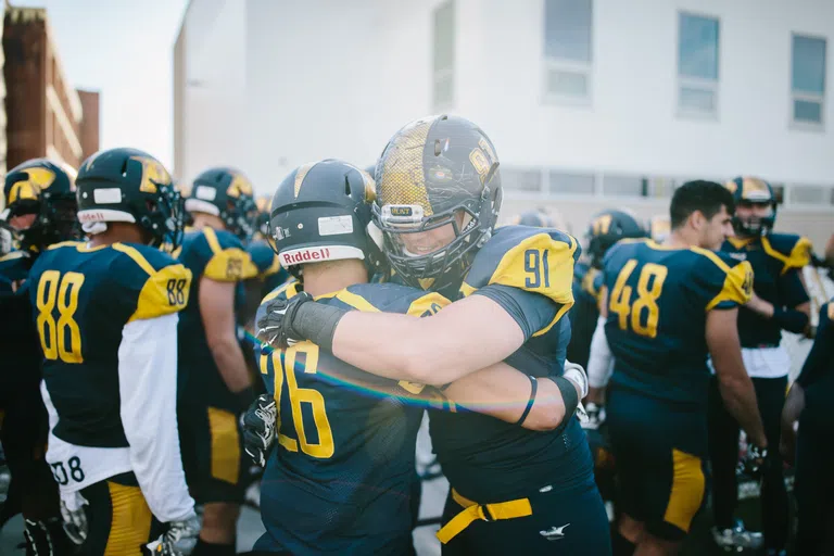 Football players embracing in victory