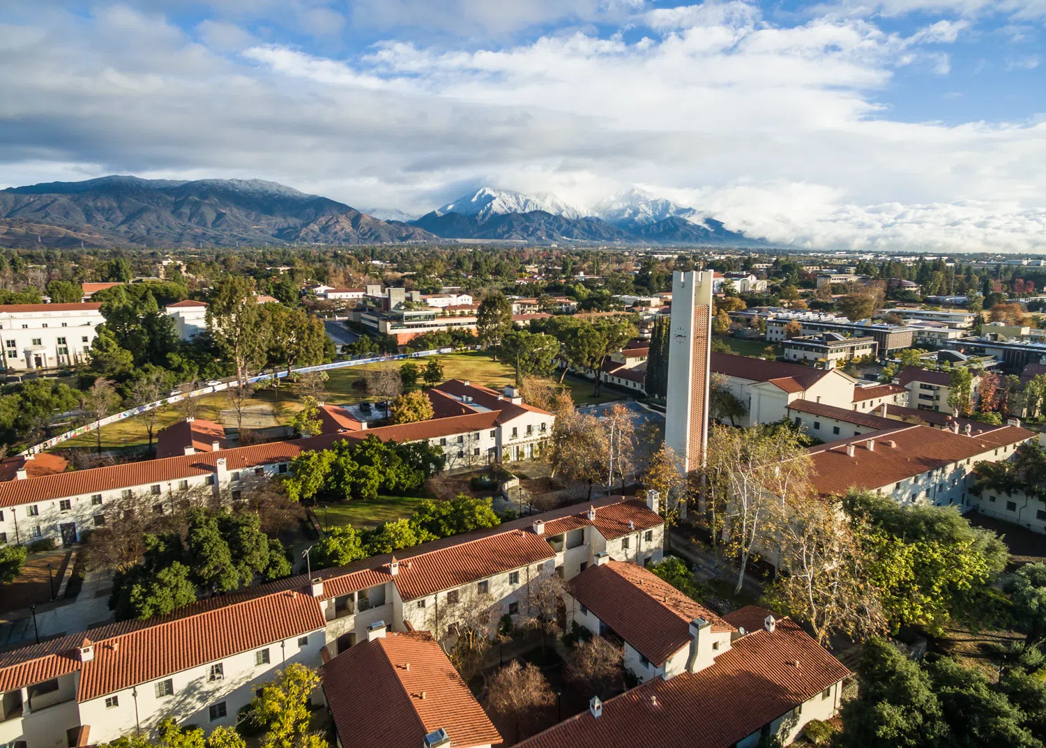 Aerial view of Pomona's campus with snow-topped San Gabriel Mountains on the horizon