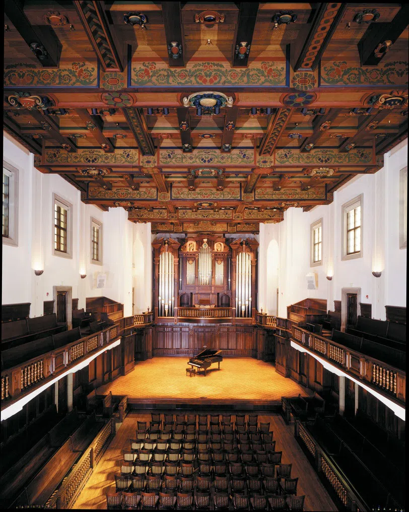 Interior view of building with grand piano at center