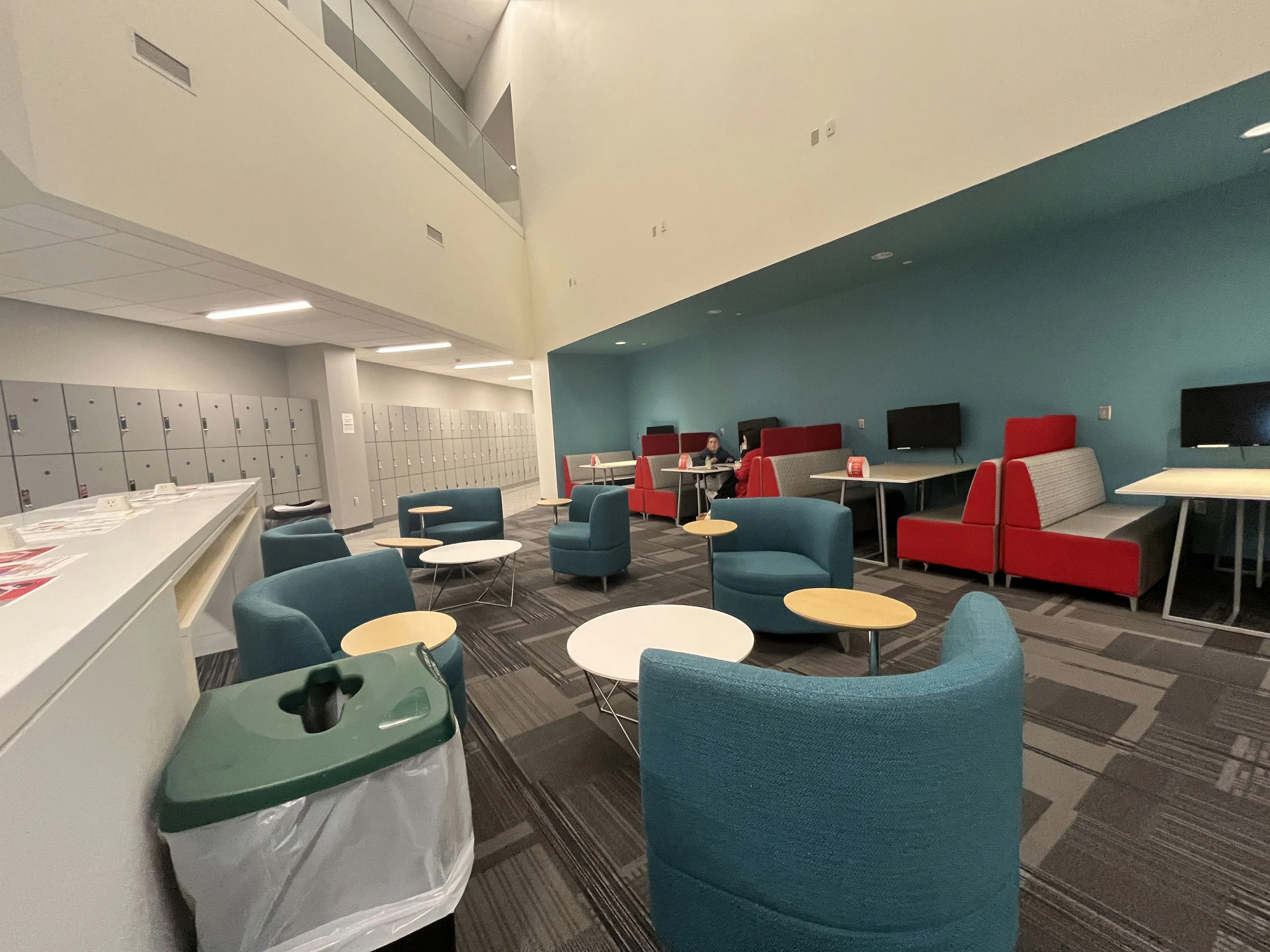 Lobby seating is located near the wall of lockers.