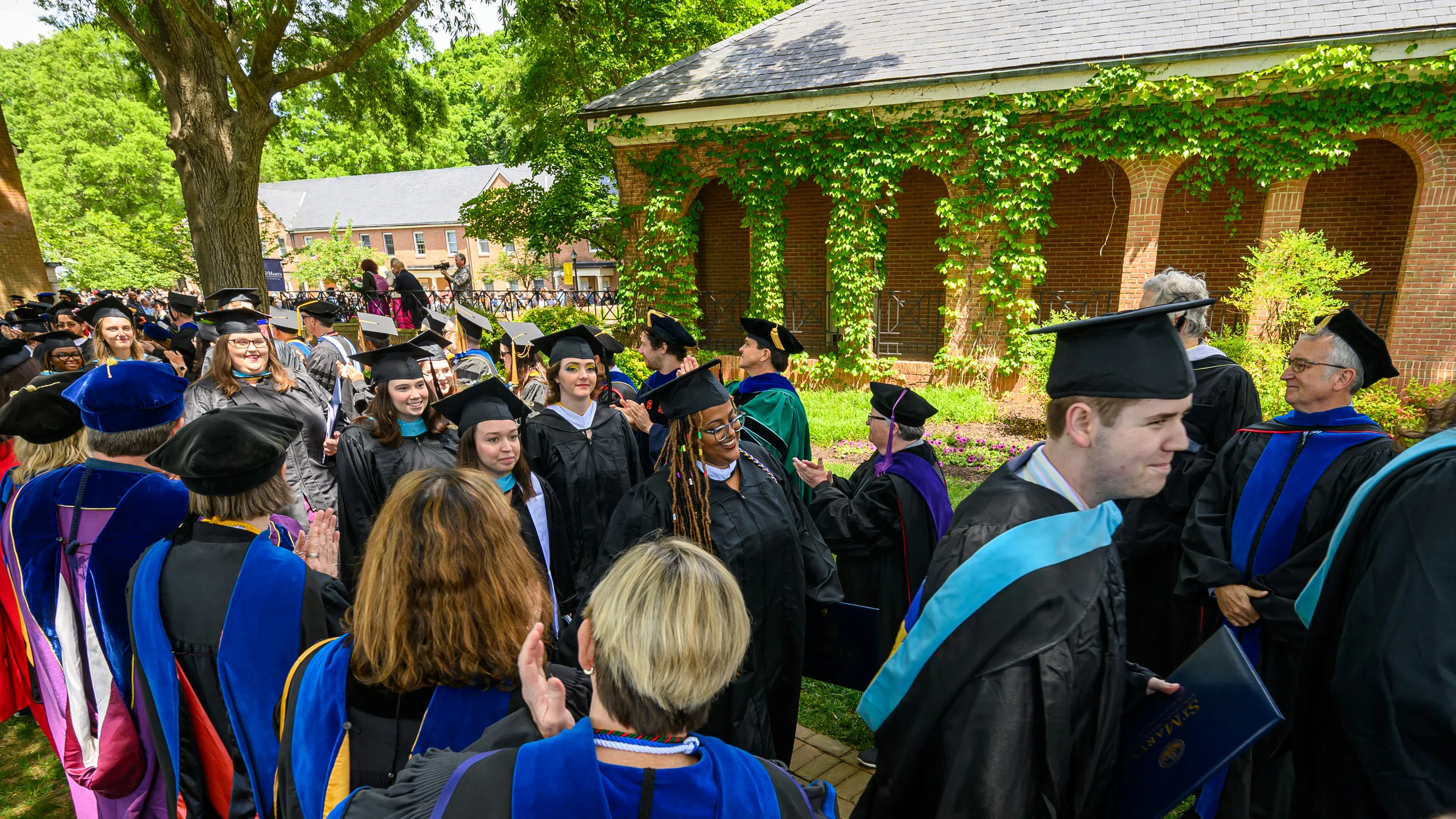 Graduates leaving the greens with diplomas in hand.