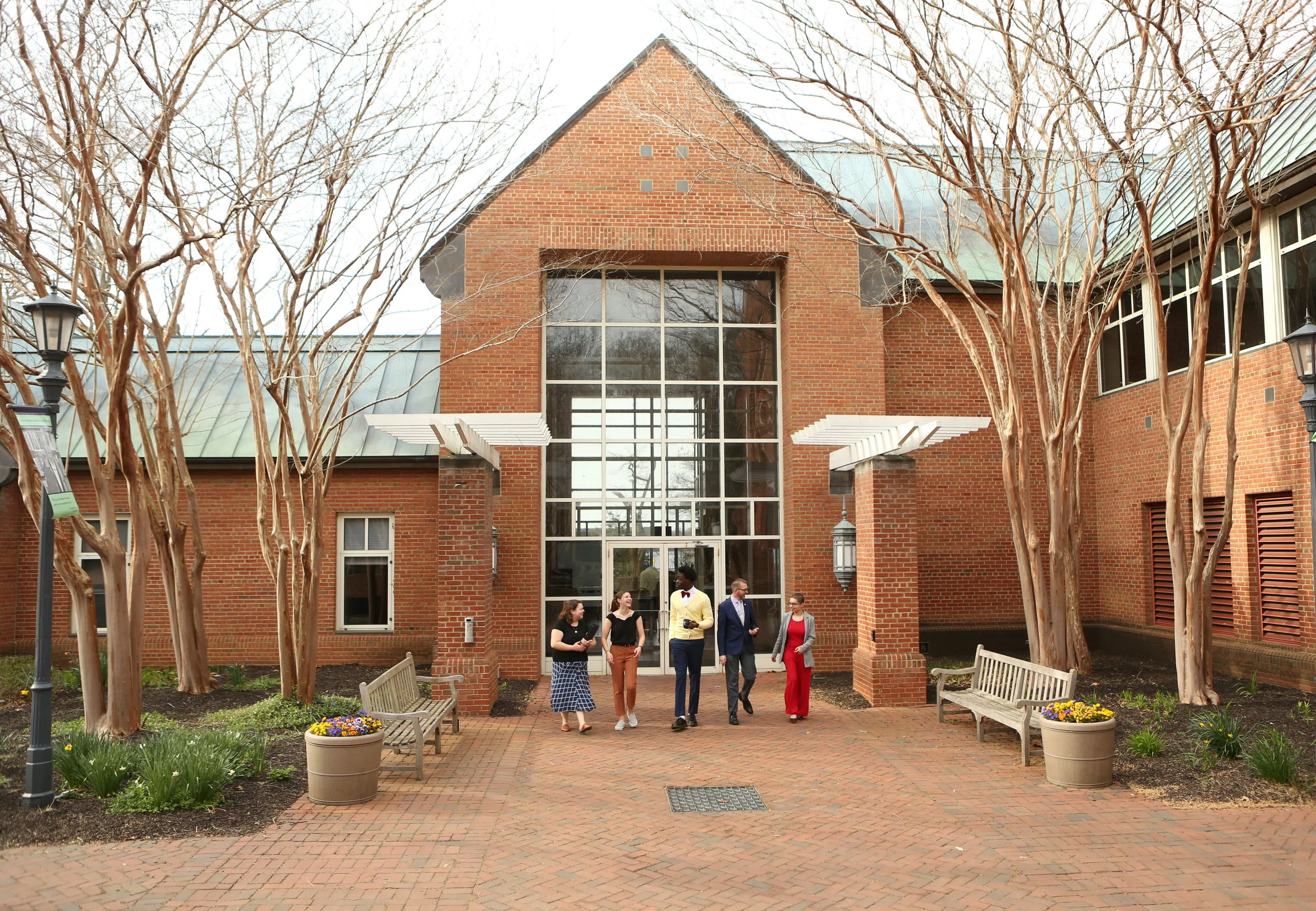 People walking away from the front entrance of the Library