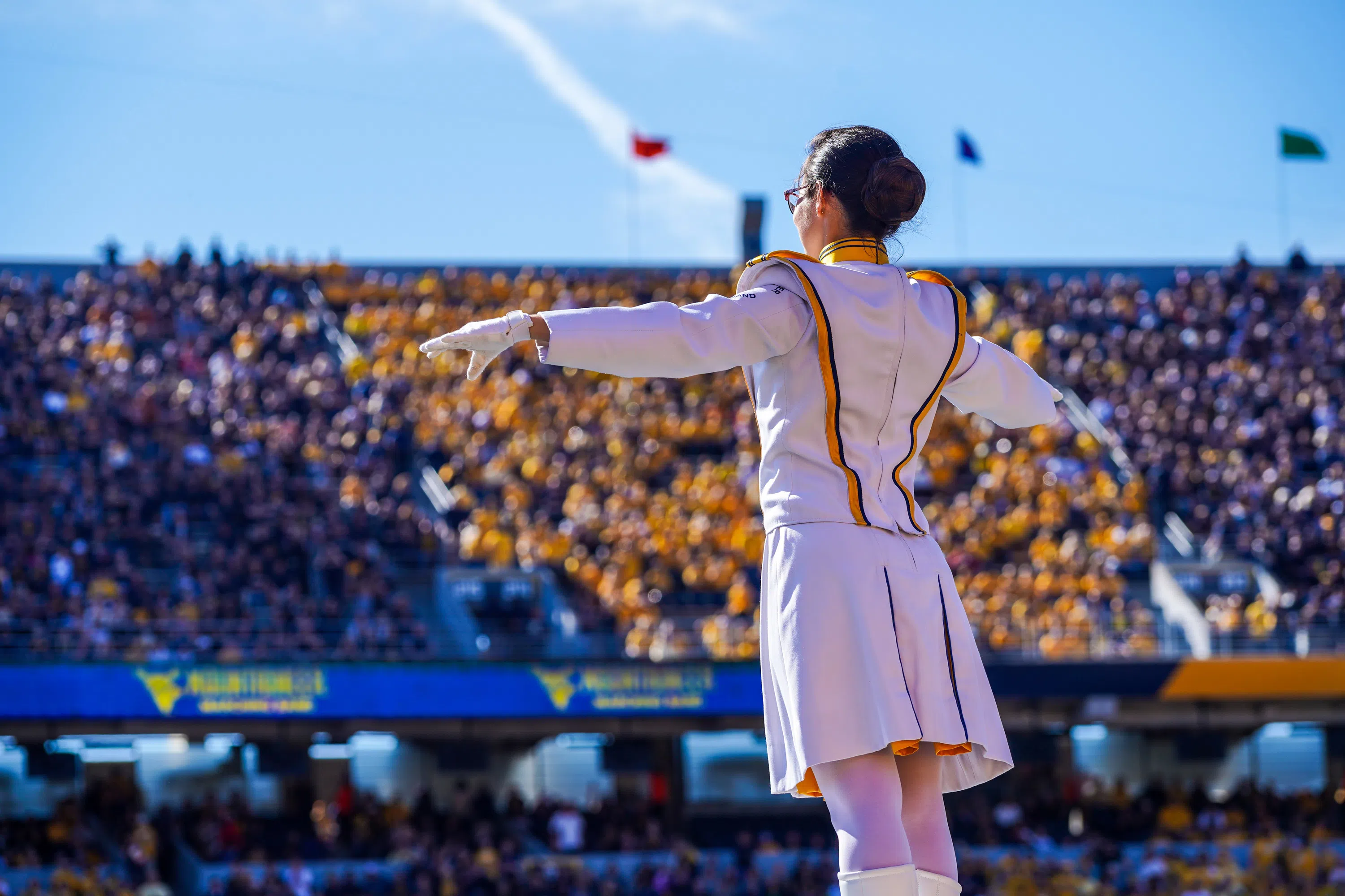 A WVU Drum Major conducts the band in the football stadium