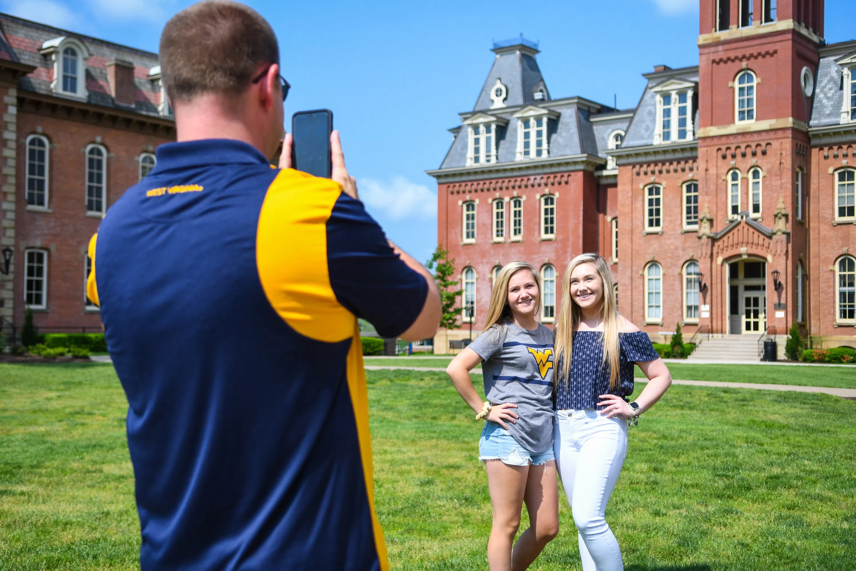 Photo of 2 students getting a selfie in front of Woodburn Hall! 