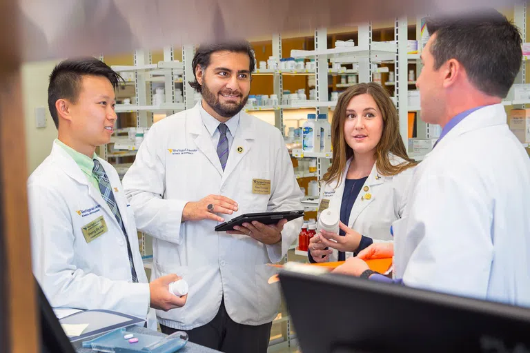 3 Pharmacists gather in the WVU Pharmacy. 