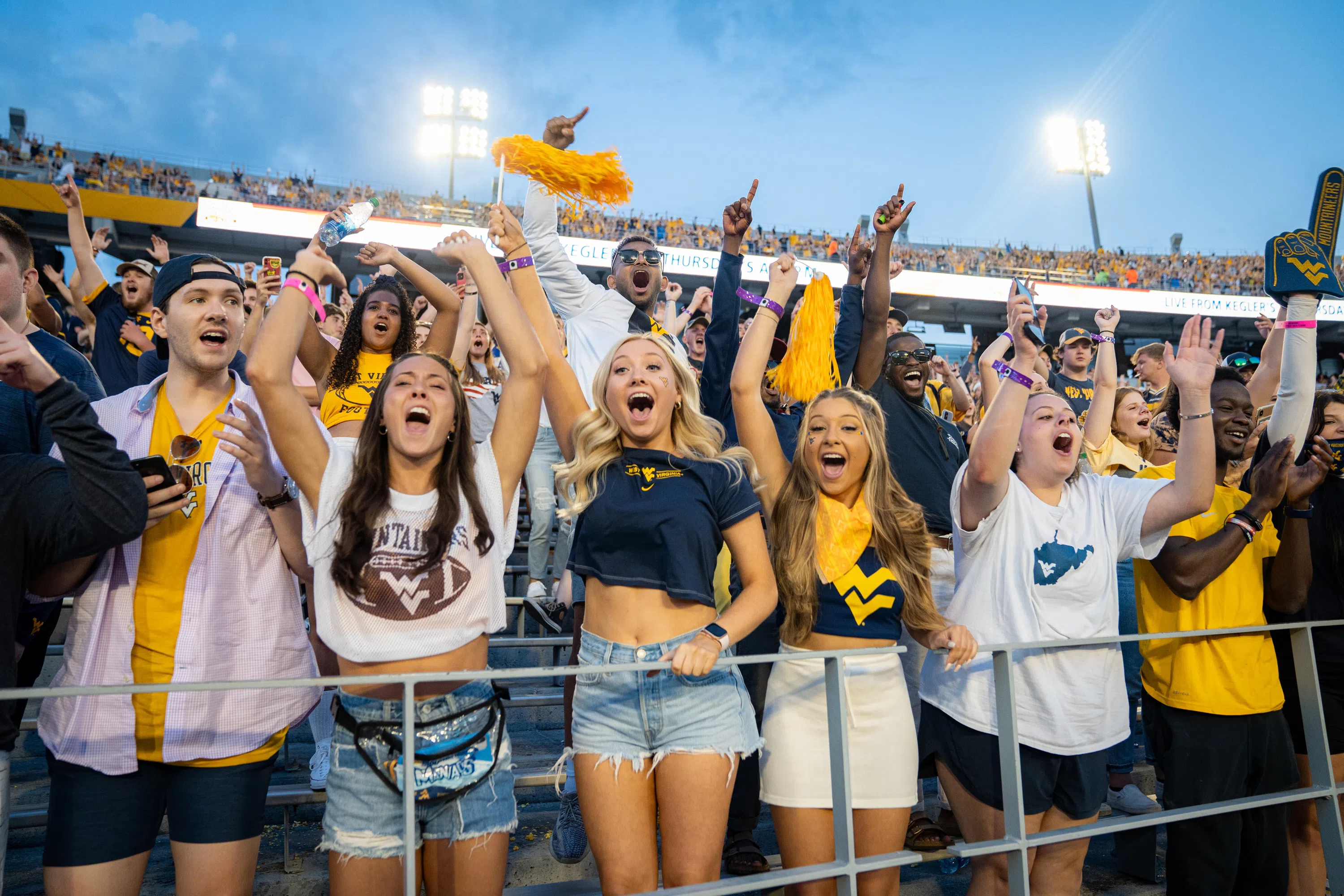 Students cheer at a football game.