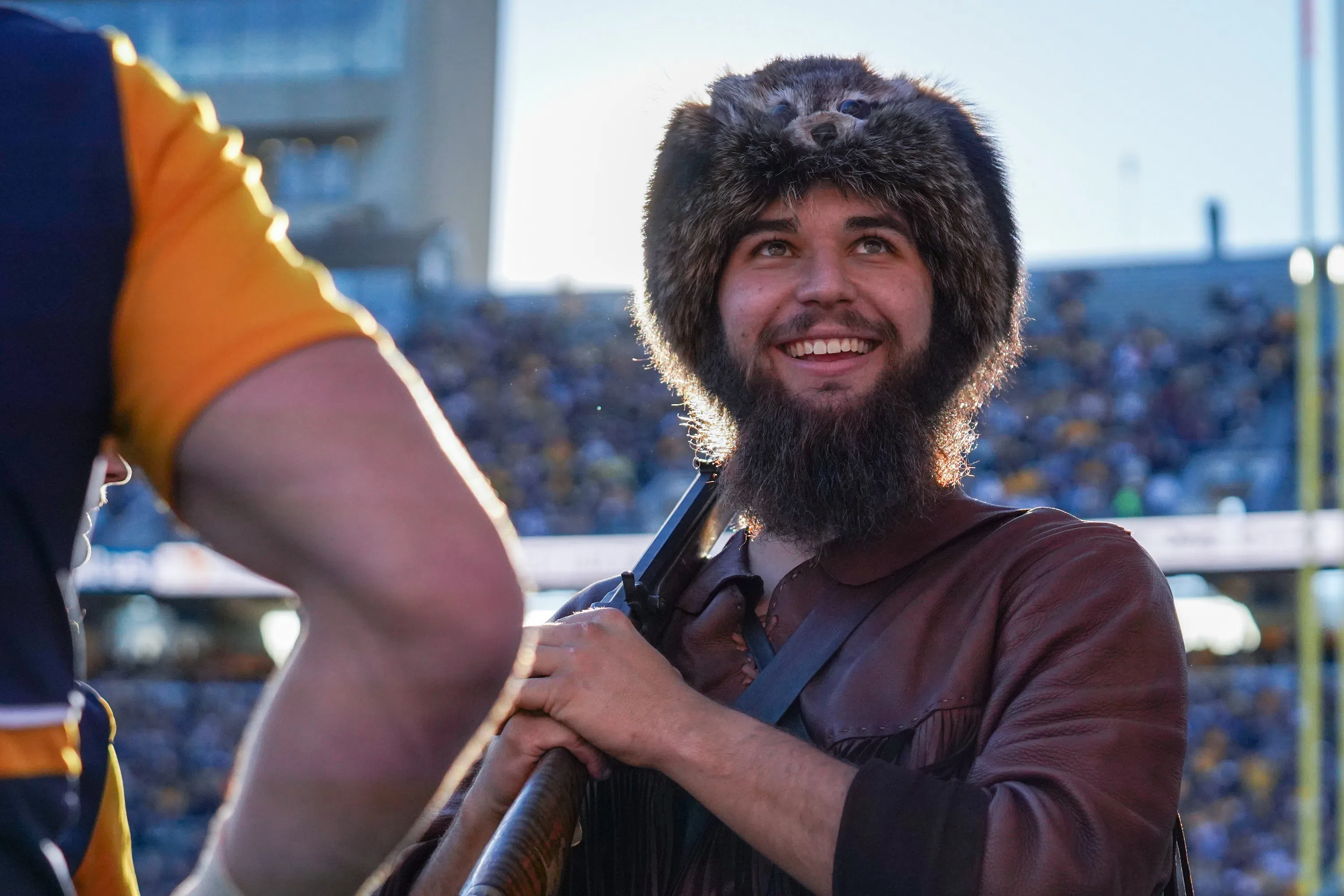 A portrait of the Mountaineer mascot smiling at a football game 