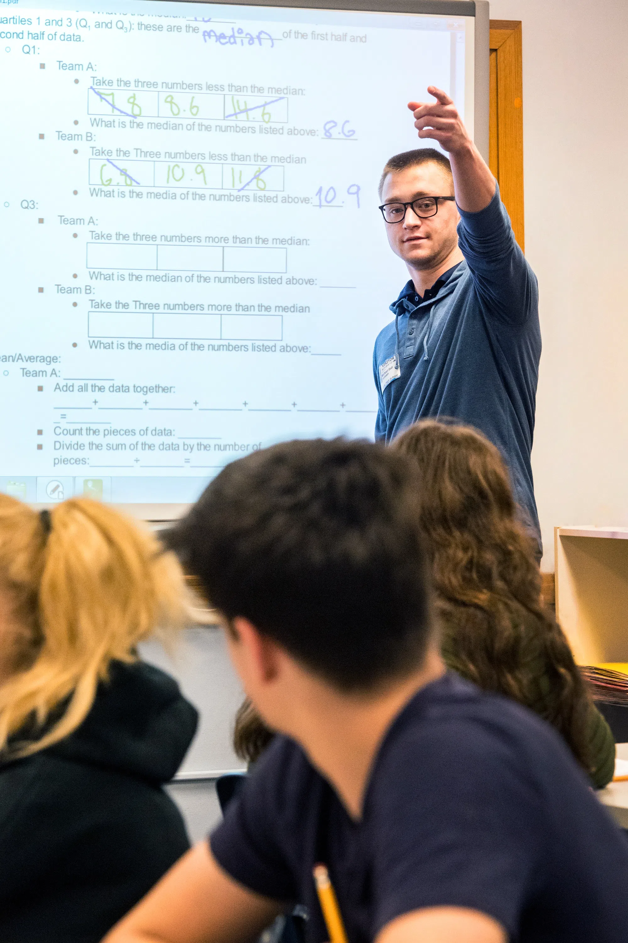 A WVU student teacher instructs a classroom full of high school students. 