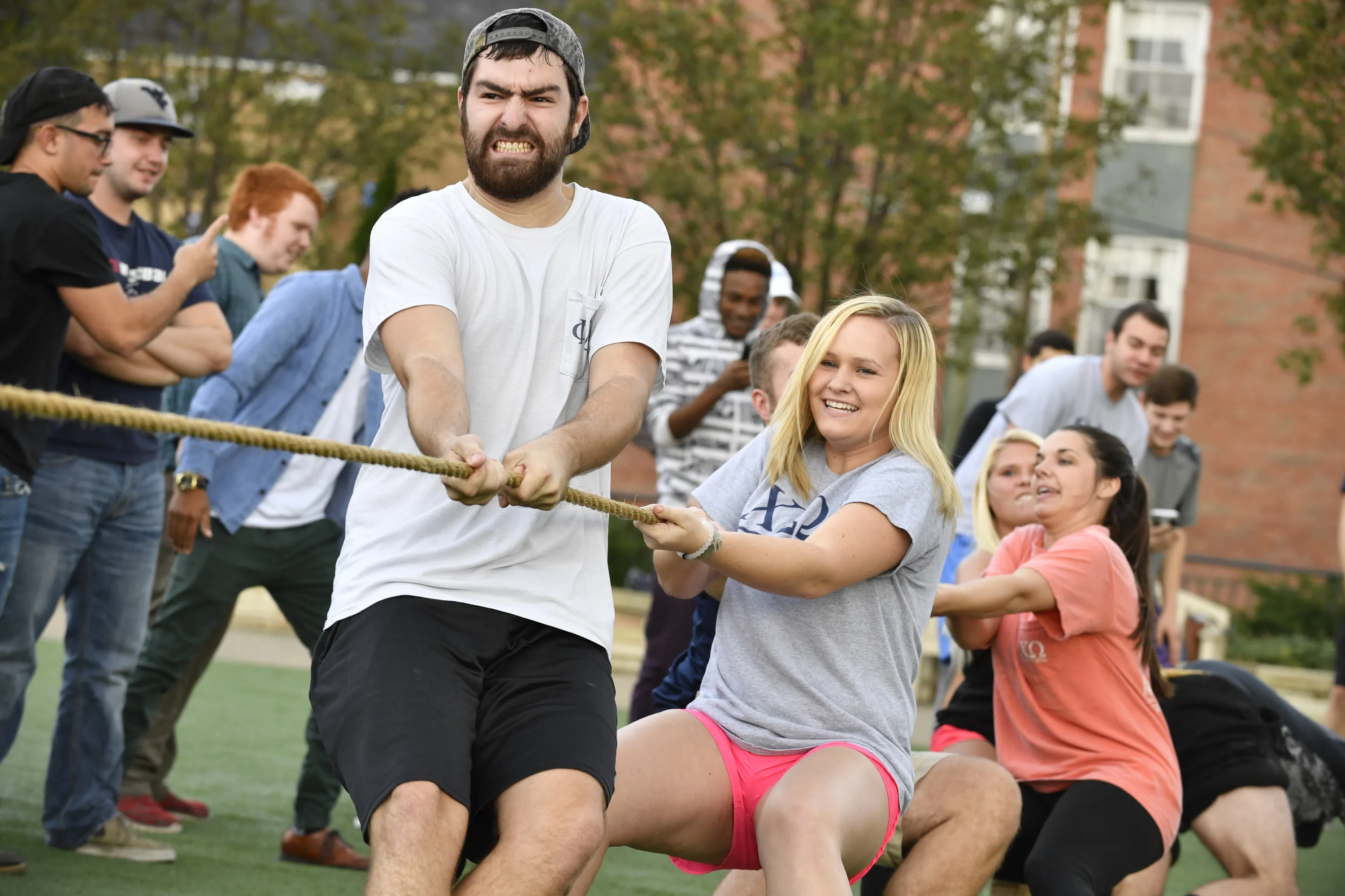 Fraternity and sorority members participate in tug of war.