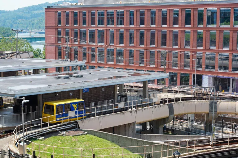 Image shows PRT platform with a car stopped at the station. 