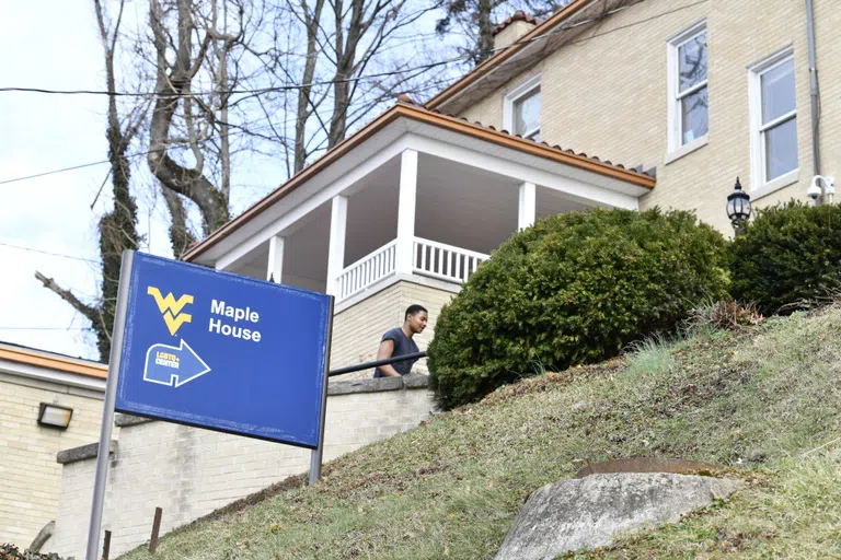 A student walks into to LGBTQ center at the Maple House 