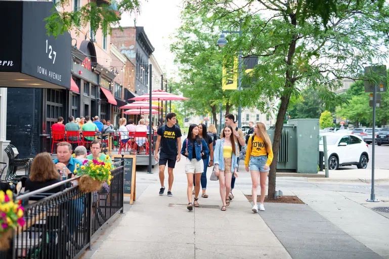 Students walking down Iowa Avenue in modeled photoshoot