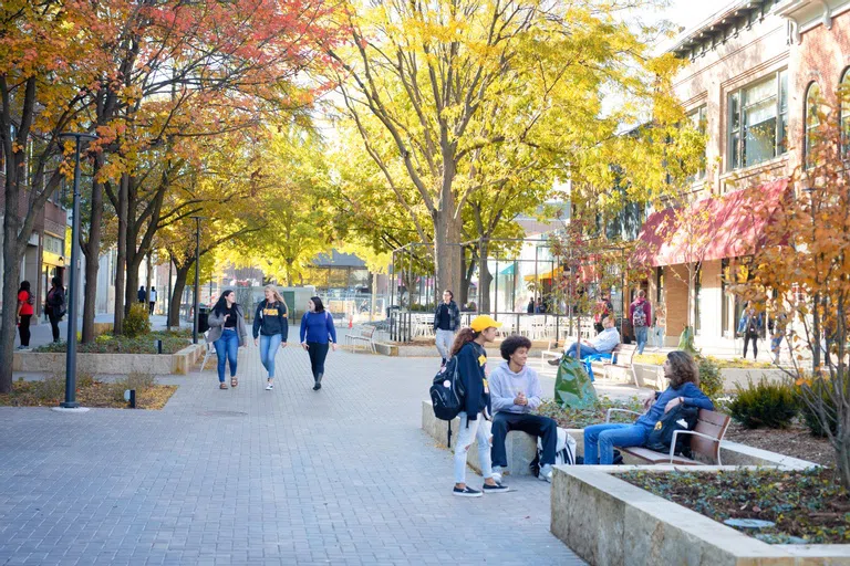 Students walking through the Pedestrian Mall in downtown Iowa City