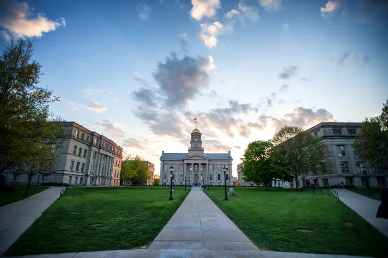 Golden hour shot of the Pentacrest with the focus on the Old Capitol building.