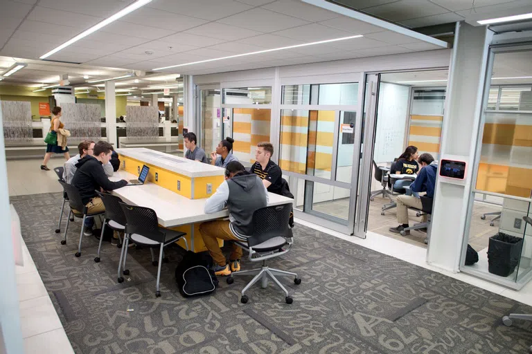 Students in various study spaces within the Main Library