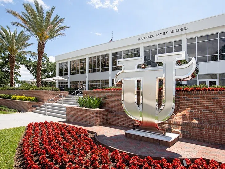 UT statue surrounded by a bed of flowers in front of the new Southard Family Building.