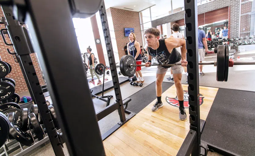 Student lifting weights