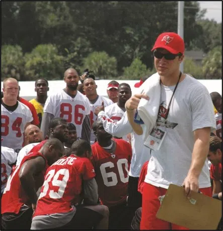 Student coaching football