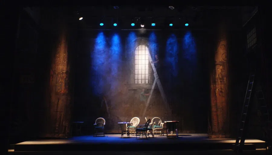 Stage set up with table and chairs and spotlight