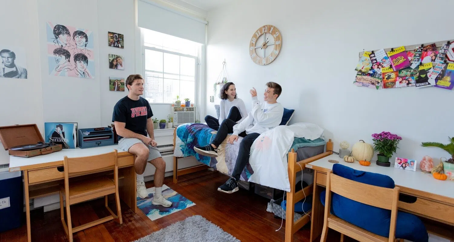 Students hang out and chat in their residence hall room