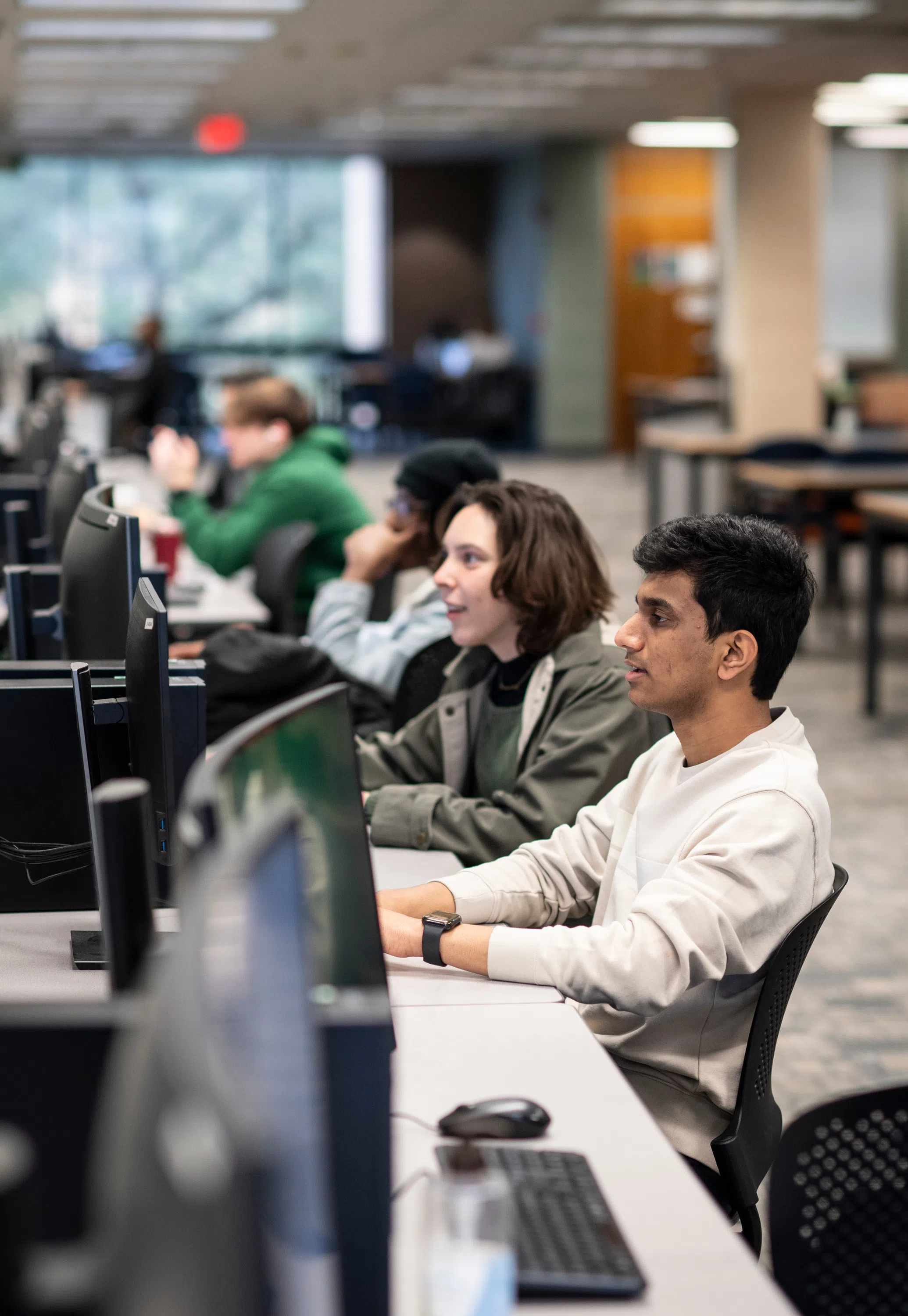 Students sit at computer workstations in Willis Library. 