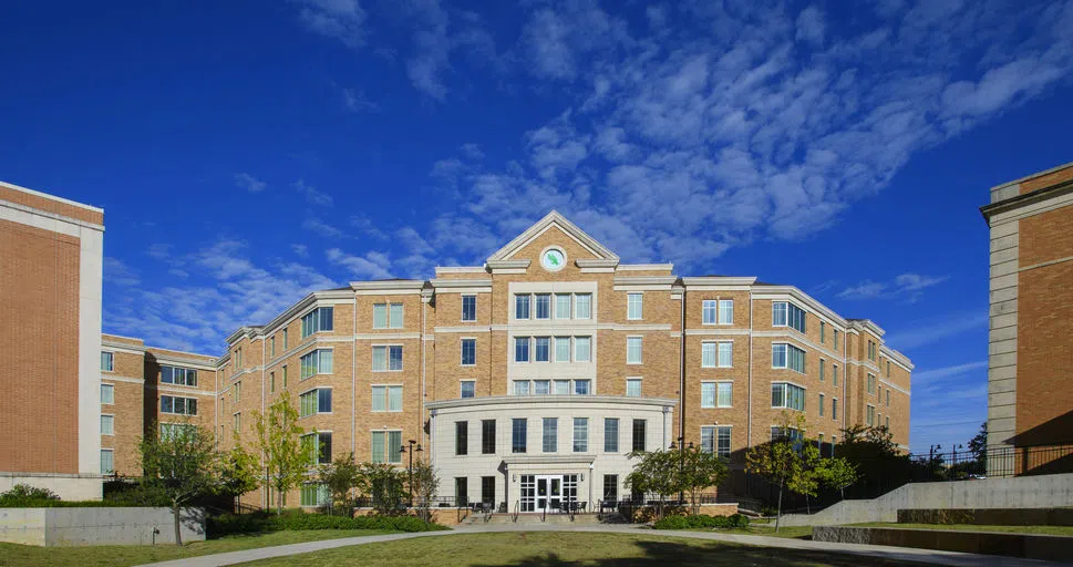  A photo of the exterior of Rawling Hall on a sunny day with a deep blue sky.