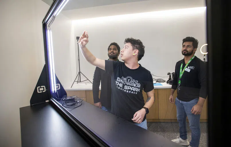 A photo of students exploring the facilities at the Spark Makerspace.