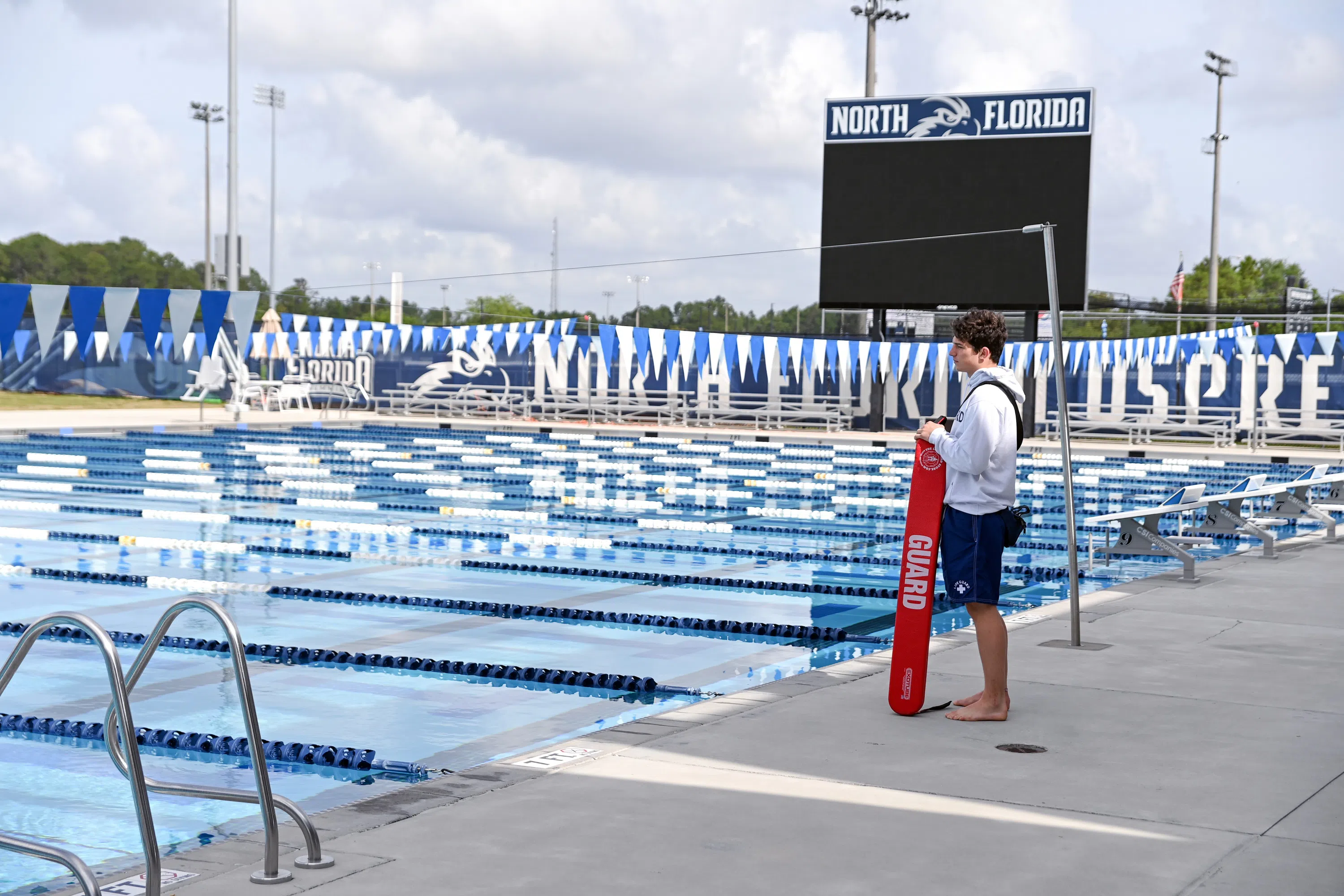 Lifeguard standing at the competition swimming pool