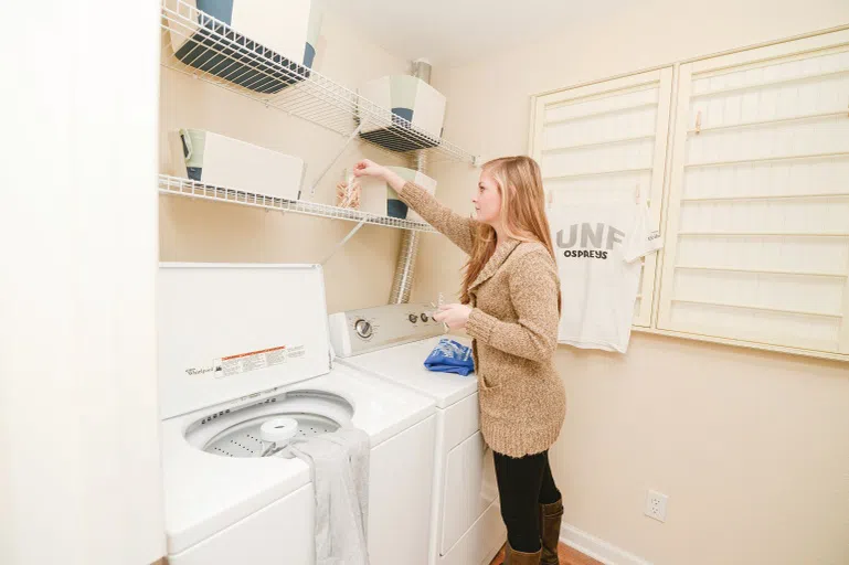 Student doing laundry in Flats