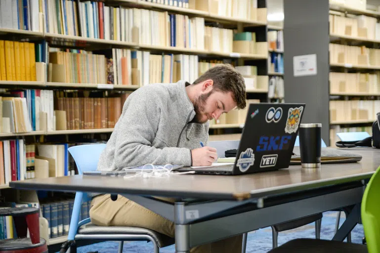 Student doing computer work in the library