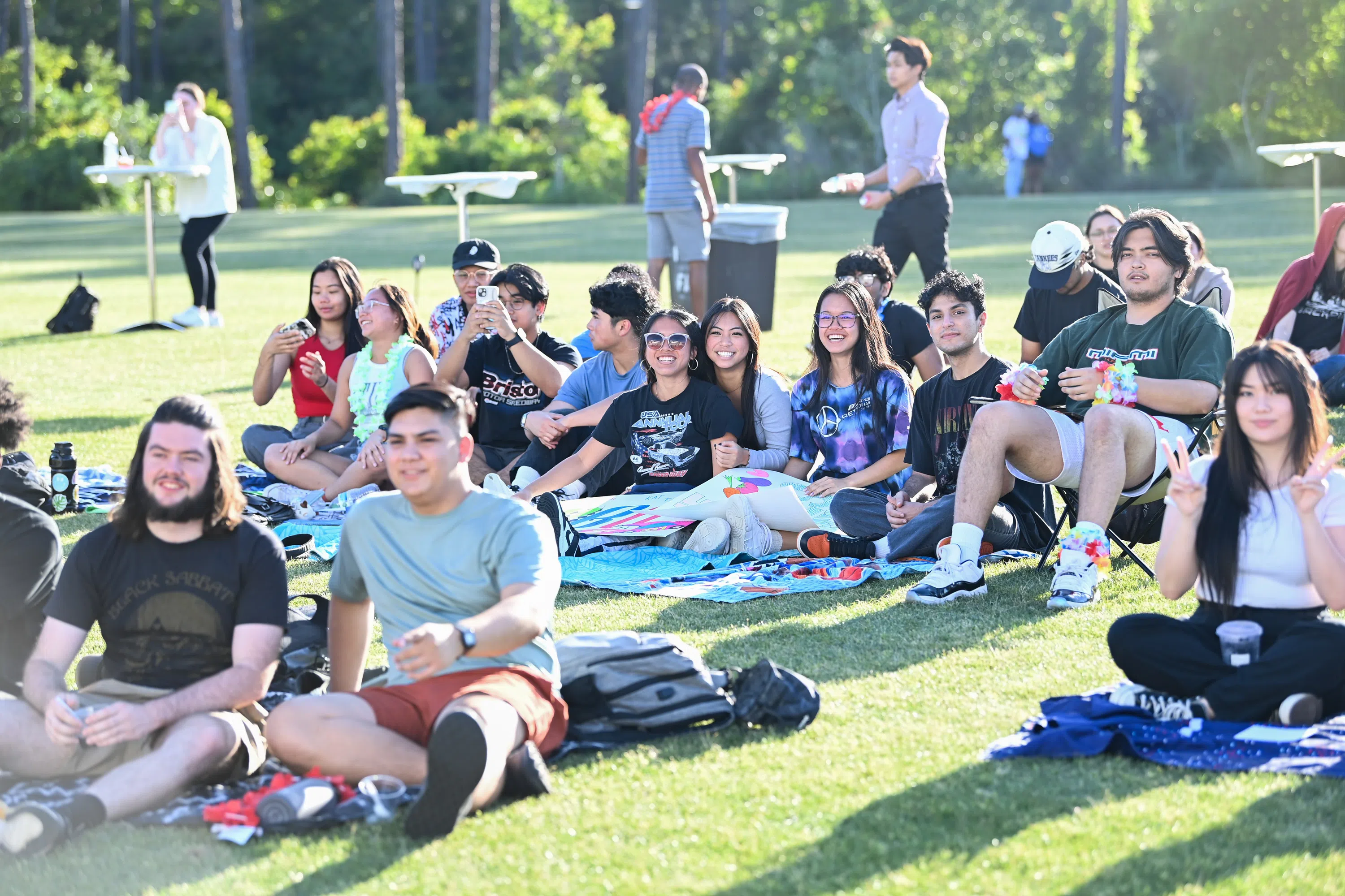 Students sitting on grass at a student led event