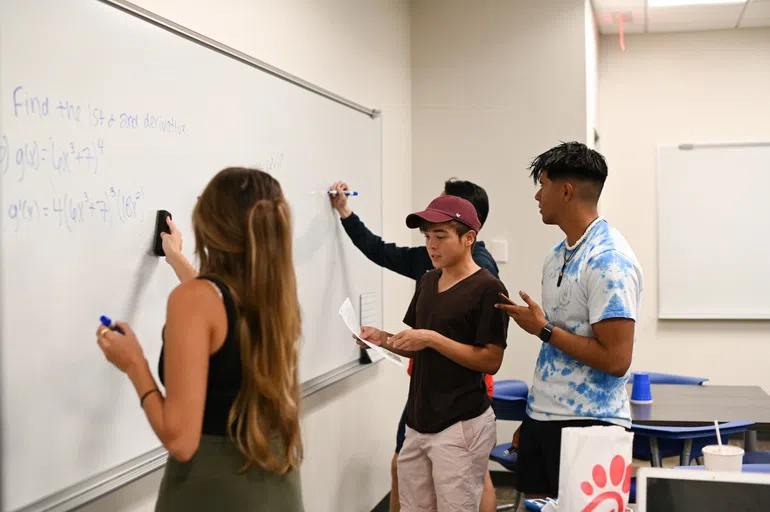 SASS Tutoring students working on whiteboard