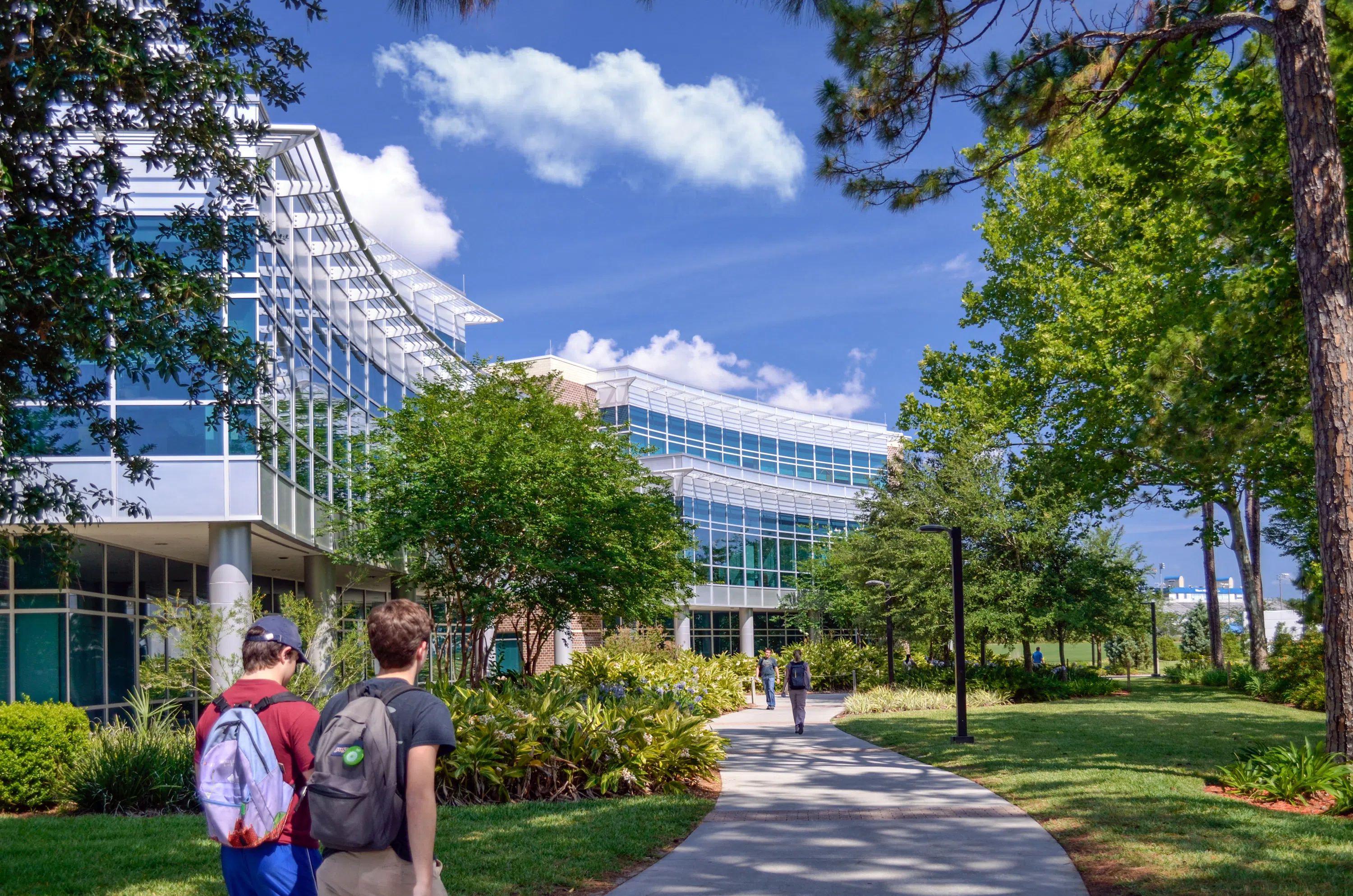 Students walking along the outside of Tom and Betty Petway Hall