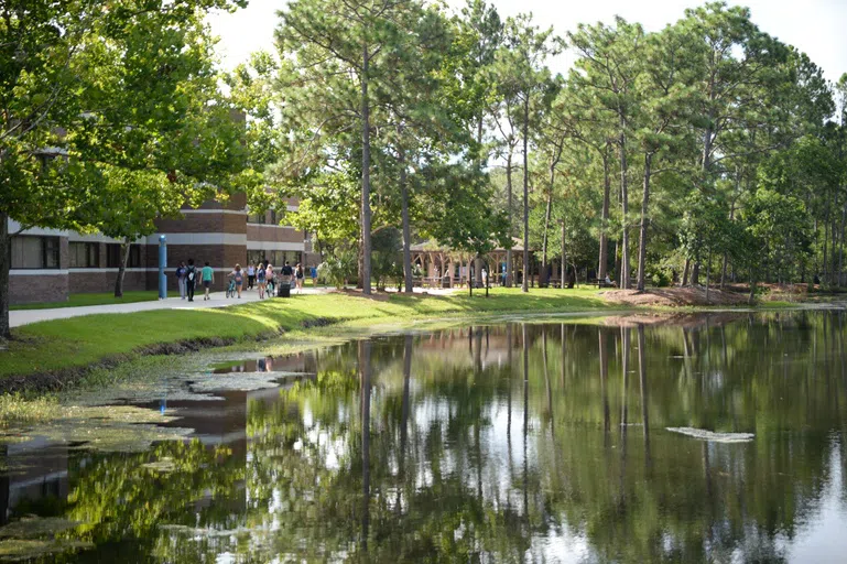 Students walking between Osprey Hall and Candy Cane Lake