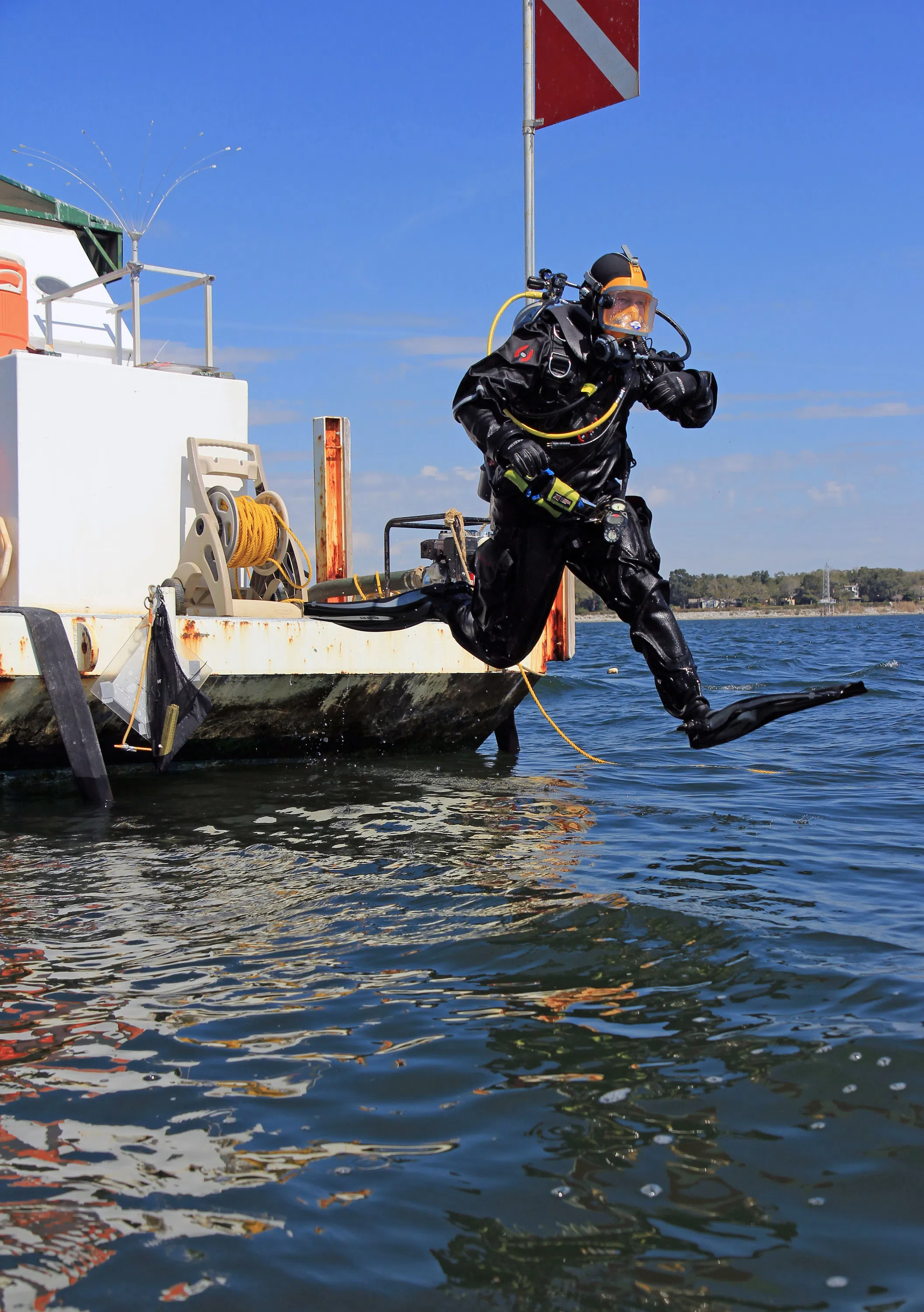 Student diving into water to research Luna shipwreck.