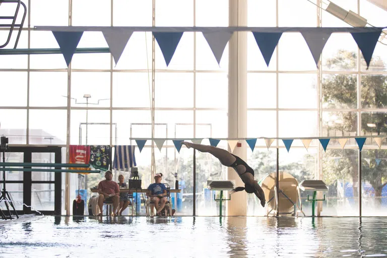 Woman diving into the UWF pool. 