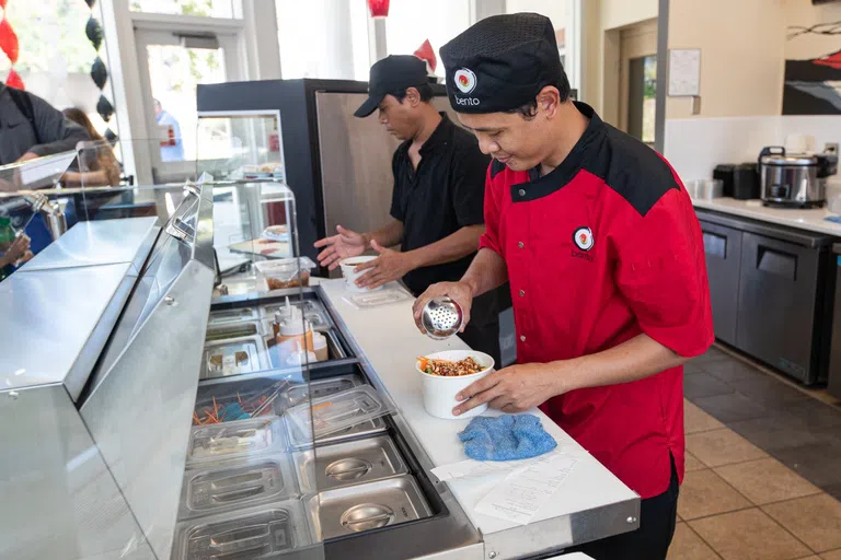 Sushi chefs preparing meals at Bento in Presidents Hall.