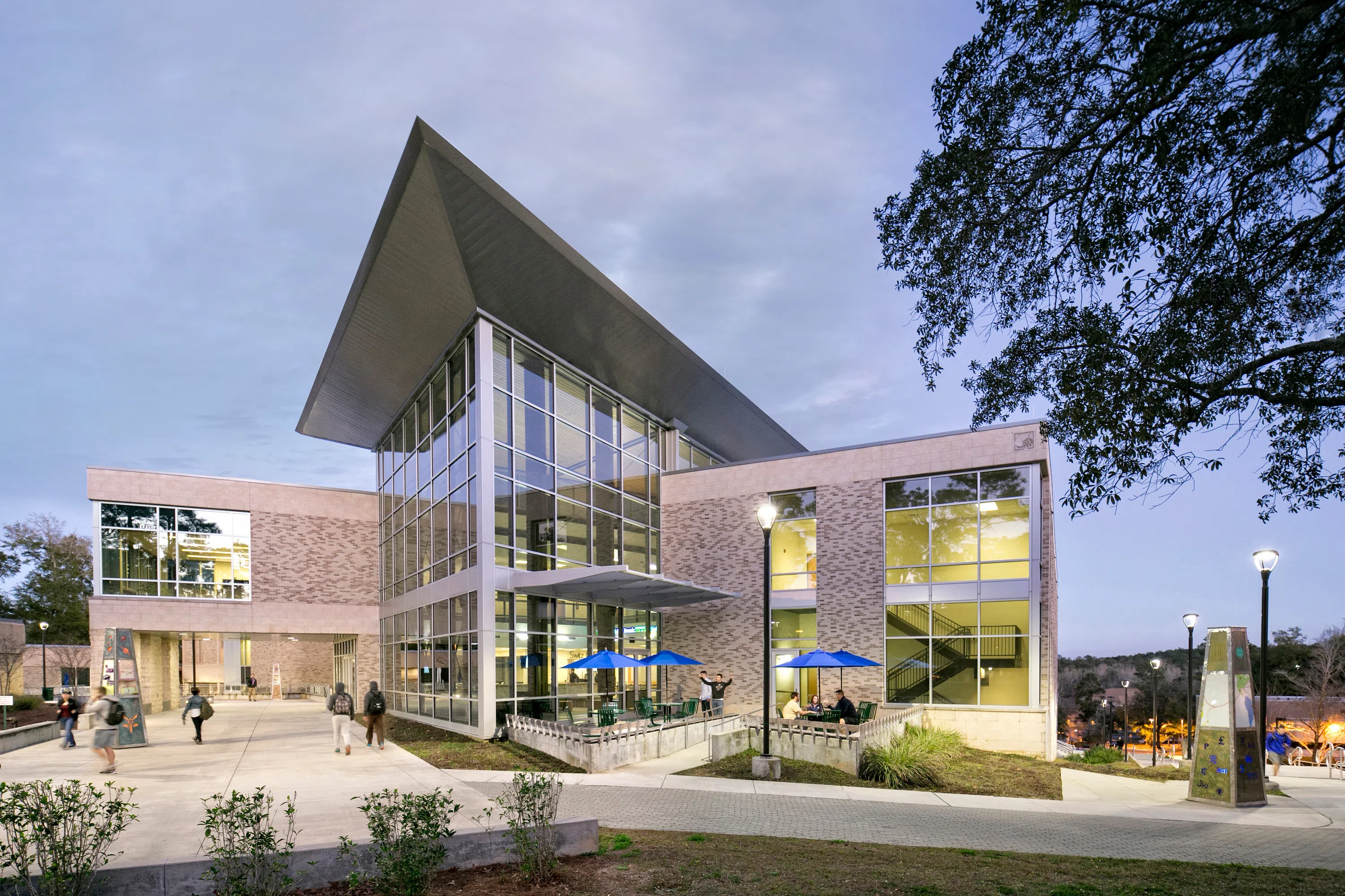 The exterior of the Lewis Bear Jr. College of Business at dusk. 