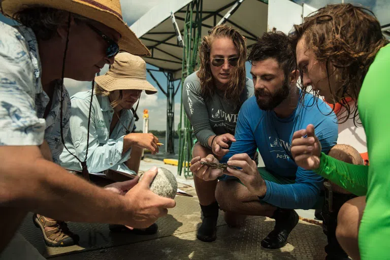 Students viewing artifacts from the Luna shipwreck site.