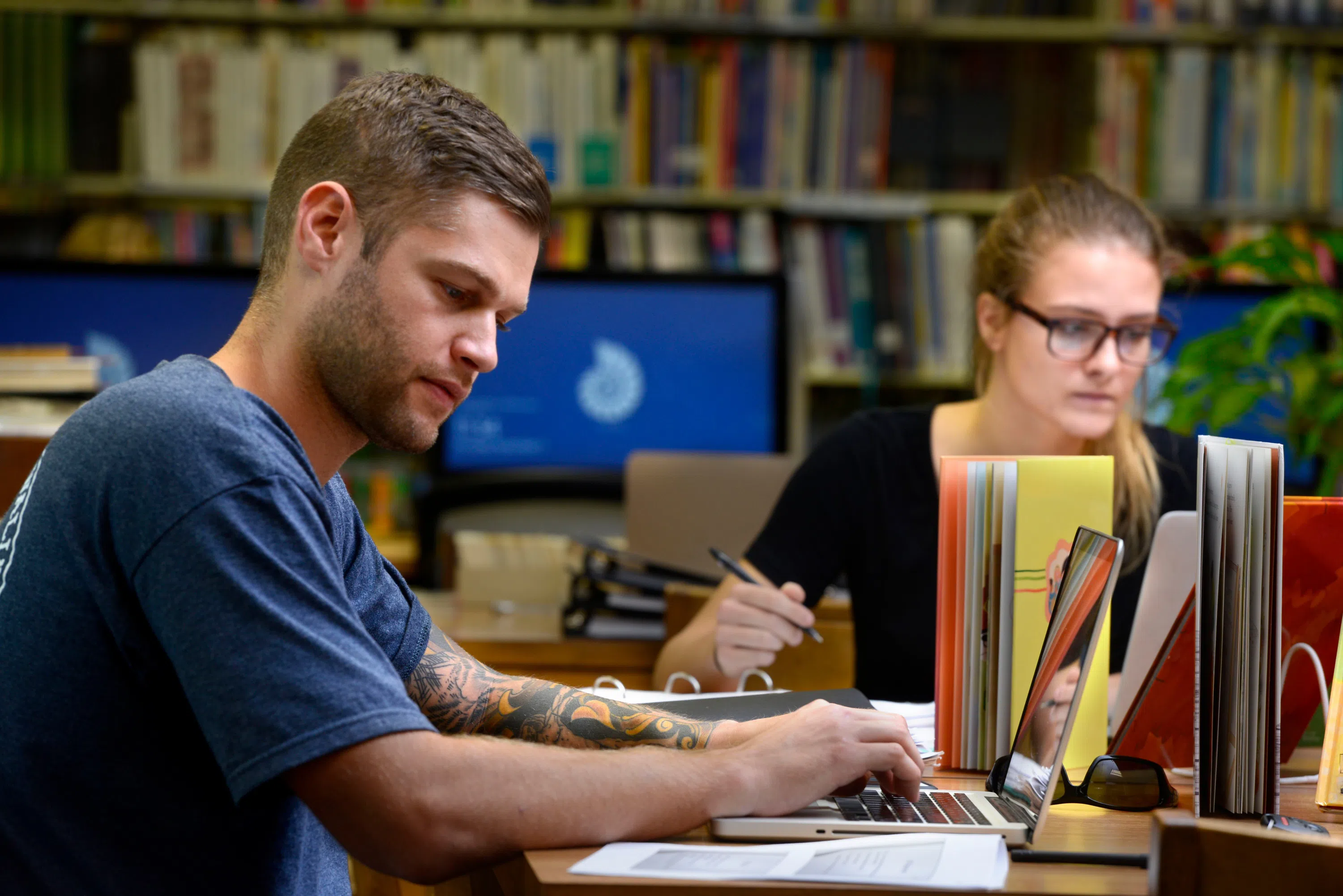 Two students study in the School of Education Library