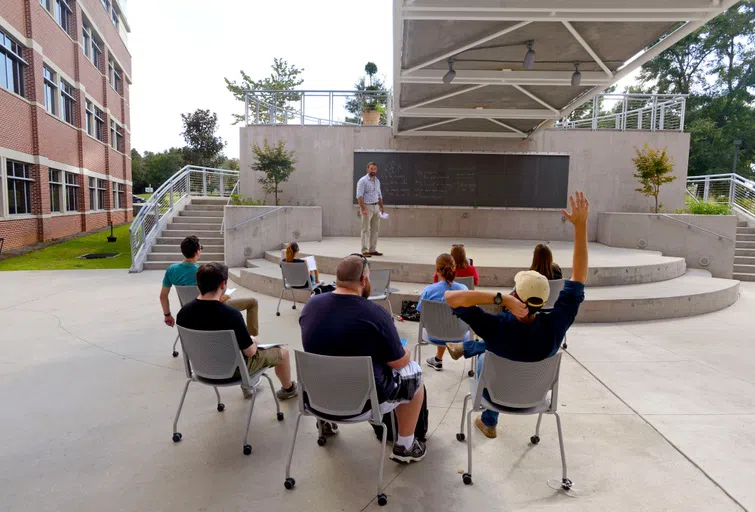 Students attending class in an outside classroom.