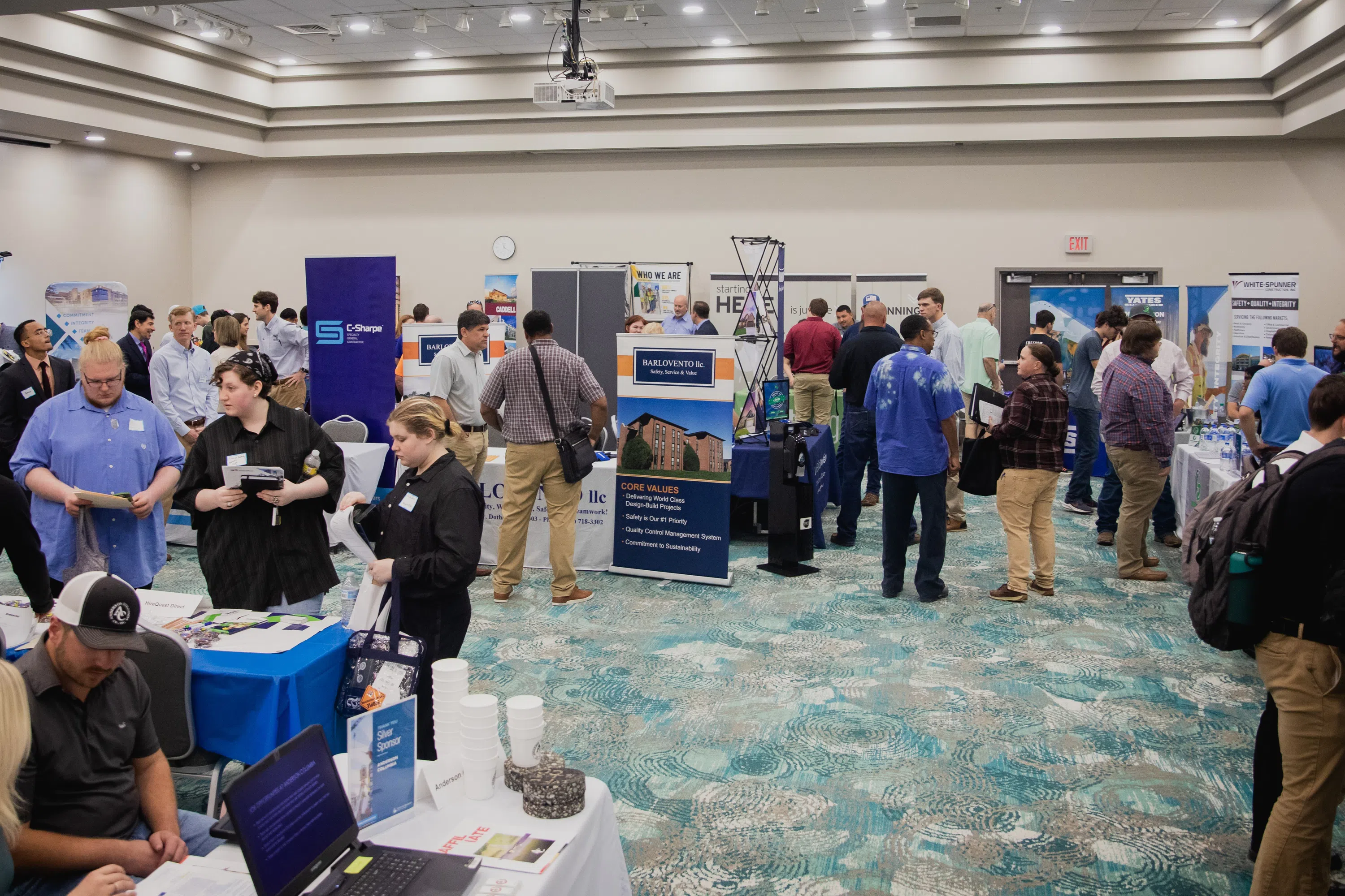 Students gather to stop at various manned tables at a Construction Management Career Fair in the Conference Center.
