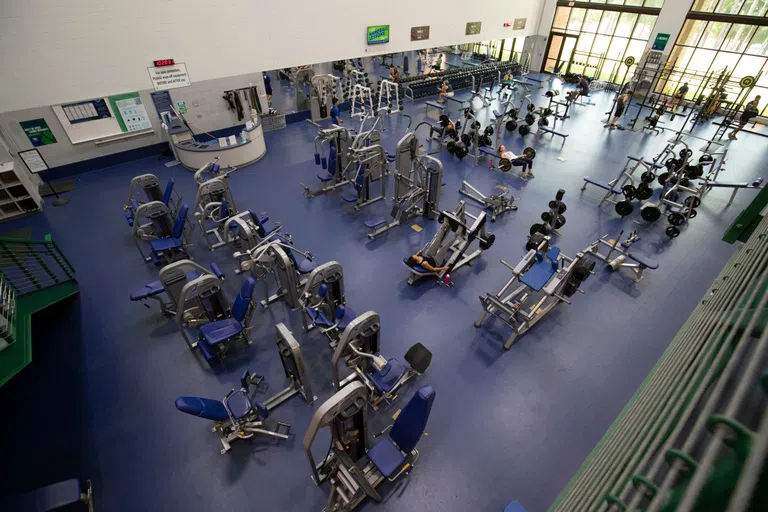 A view from the second floor looking down on the weight room below. 