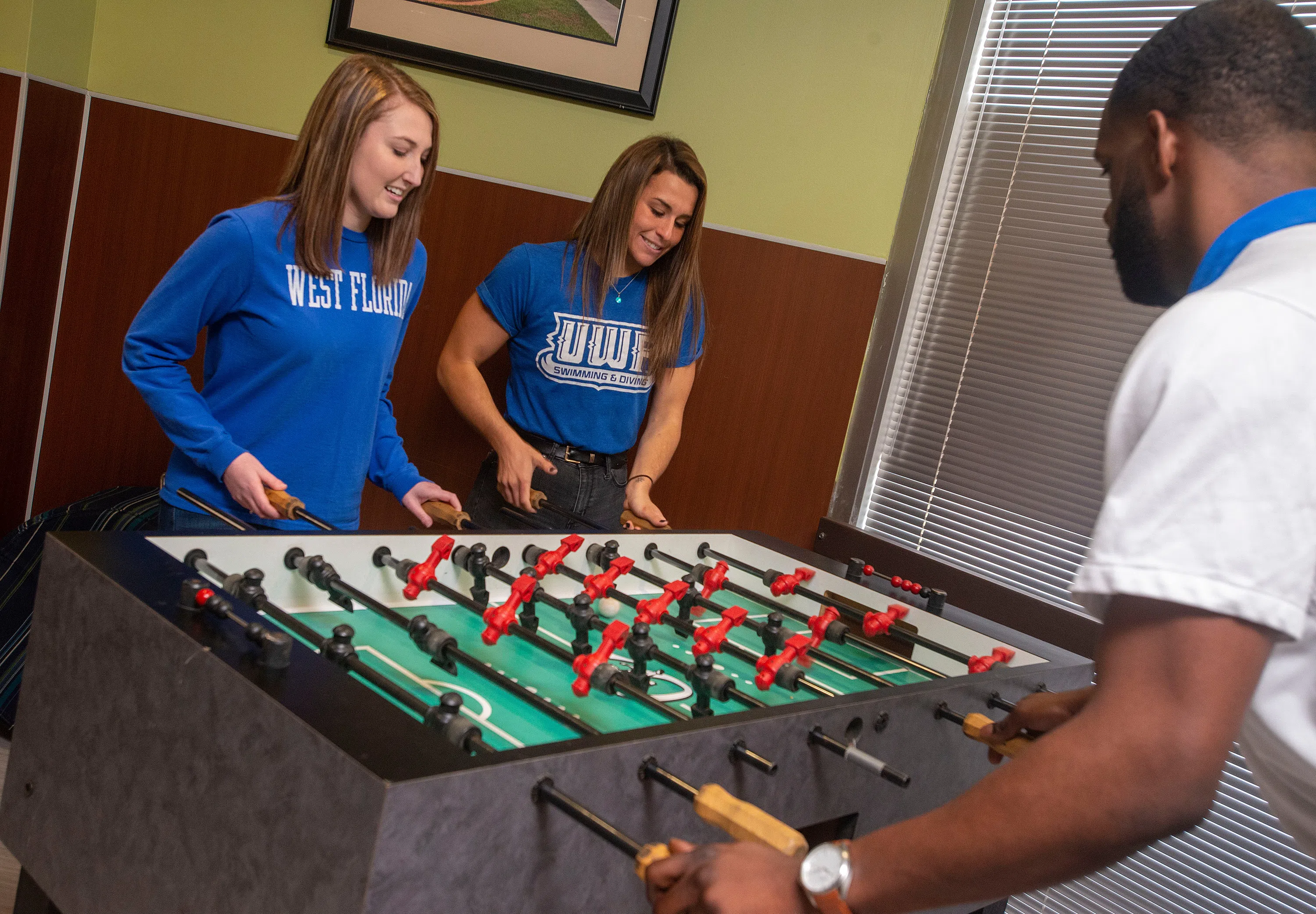 Students playing foosball in the Argo Galley