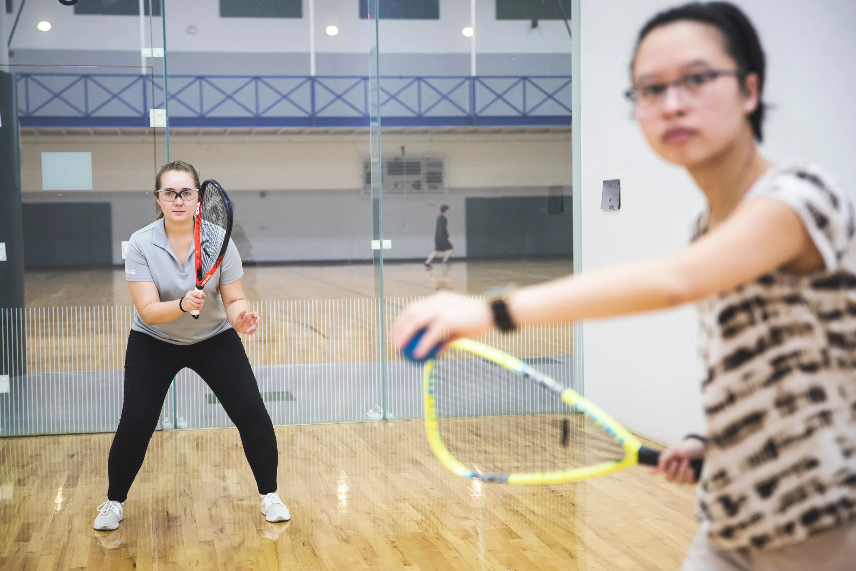 Two women playing racquetball.