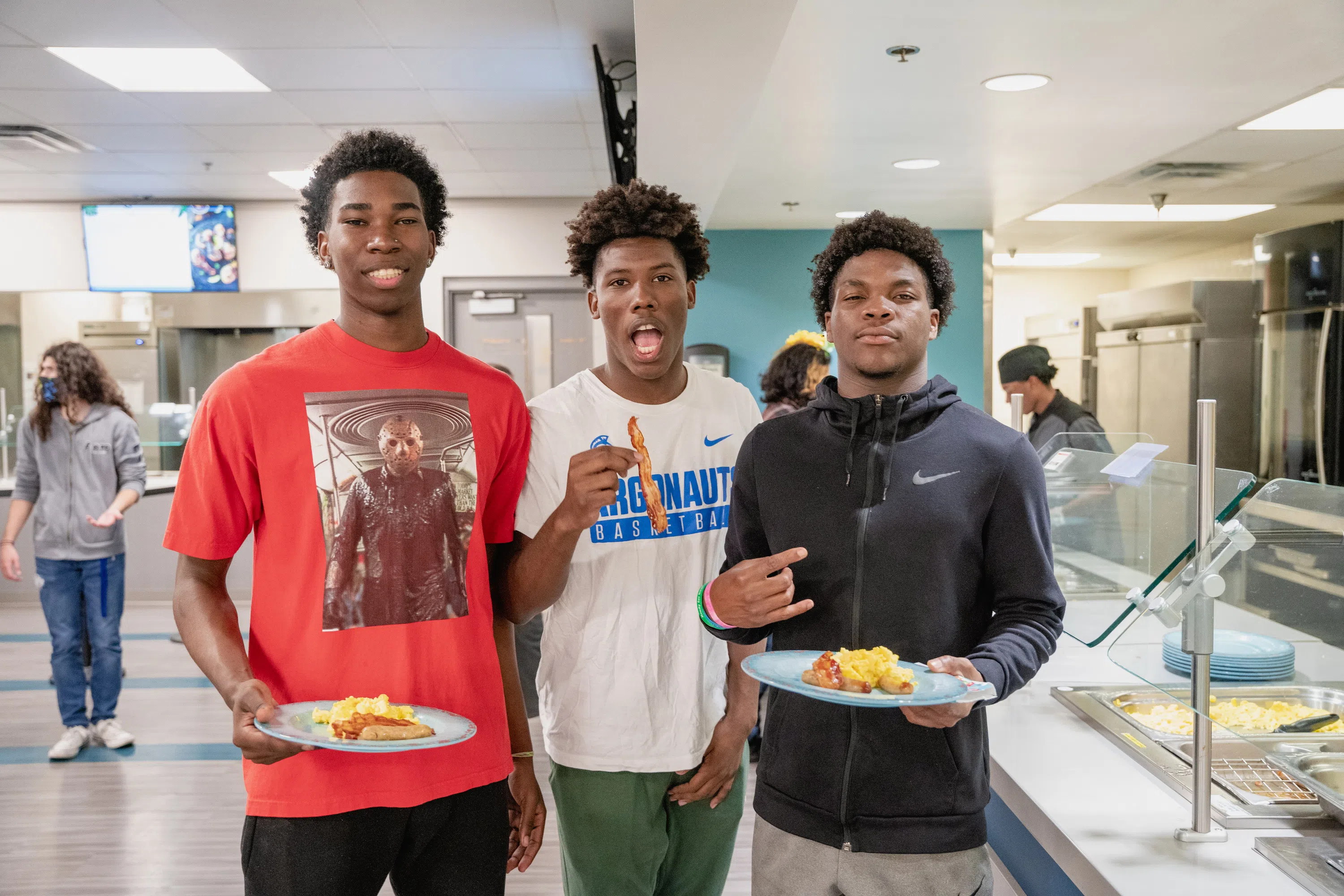 Three students enjoying breakfast from the Nautilus Market.