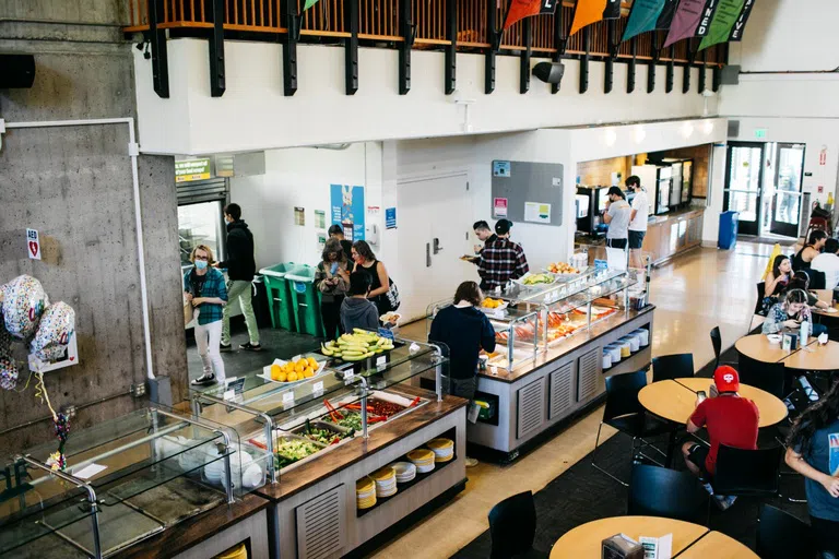 Students take food from the buffet